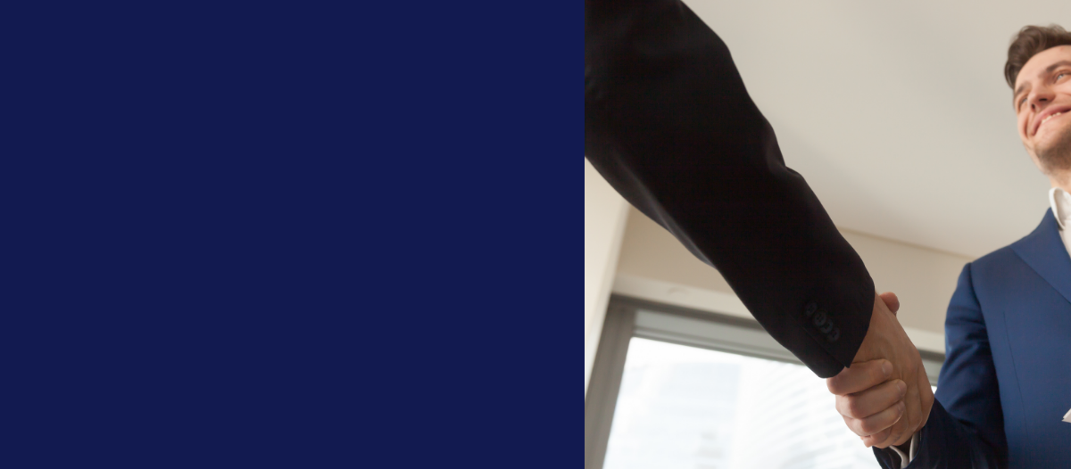 Person in a suit adjusting a watch near a window.