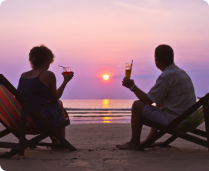 A man and woman at the beach discussing consumer financial services