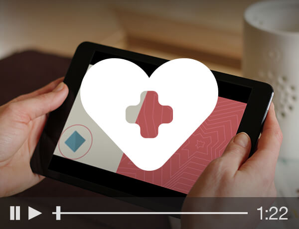 A white heart icon over a tablet